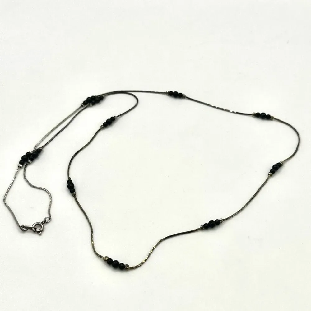 Black and silver tone long beaded necklace